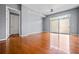 Spacious apartment living room with hardwood floors and access to a balcony at 711 Cosmopolitan Ne Dr # 213, Atlanta, GA 30324