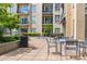 A community patio featuring tables and chairs with condominium buildings in the background at 711 Cosmopolitan Ne Dr # 213, Atlanta, GA 30324