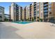 Large community pool surrounded by multiple condominium buildings at 711 Cosmopolitan Ne Dr # 213, Atlanta, GA 30324
