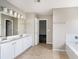 Spacious bathroom has double sinks, tub, and tile floors at 8908 Brandy Rose, Douglasville, GA 30134