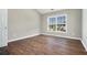 Bright bedroom with hardwood floors, large window and neutral paint, ready for personalization at 8908 Brandy Rose, Douglasville, GA 30134