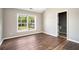 This bedroom has wood floors, a window, and an ensuite bathroom at 8908 Brandy Rose, Douglasville, GA 30134