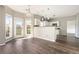 Bright dining area with hardwood floors, updated lighting, adjacent to an open-concept kitchen at 8908 Brandy Rose, Douglasville, GA 30134