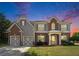 Charming two-story home with brick and gray siding, updated garage door, shutters and manicured front yard at 8908 Brandy Rose, Douglasville, GA 30134