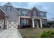 Traditional brick and siding home with covered front porch and two-car garage at 8908 Brandy Rose, Douglasville, GA 30134