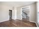 Bright living room with wood floors, and view of the staircase at 8908 Brandy Rose, Douglasville, GA 30134