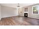 Inviting living room with hardwood floors, fireplace, large windows, and neutral paint at 8908 Brandy Rose, Douglasville, GA 30134