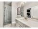 Clean, modern bathroom features a glass enclosed shower, toilet, and sink with a large framed mirror at 1129 Cordia Nw Ave, Atlanta, GA 30318