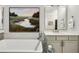 Luxurious bathroom featuring a standalone tub and stylish vanity with a large landscape painting at 1129 Cordia Nw Ave, Atlanta, GA 30318