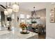 Dining area featuring a modern chandelier, decorative wall paneling, and windows at 1129 Cordia Nw Ave, Atlanta, GA 30318