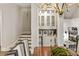 Dining room featuring an elegant chandelier and view into the hall, pantry, and staircase at 1129 Cordia Nw Ave, Atlanta, GA 30318