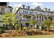 A townhome boasts a balcony, manicured yard, and stone accents, blending luxury with outdoor charm at 1129 Cordia Nw Ave, Atlanta, GA 30318