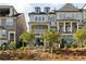 A townhouse featuring a balcony, stone accents, and a beautifully landscaped yard with steps at 1129 Cordia Nw Ave, Atlanta, GA 30318