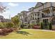 A row of elegant townhomes with brick and stone exteriors, featuring balconies and landscaped front yards at 1129 Cordia Nw Ave, Atlanta, GA 30318