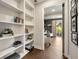 Bright hallway with built-in shelves and an open view to a living room and an outdoor patio at 1129 Cordia Nw Ave, Atlanta, GA 30318