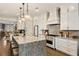 Gourmet kitchen featuring a central island with barstool seating, white cabinetry, and stainless appliances at 1129 Cordia Nw Ave, Atlanta, GA 30318