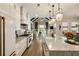 Open concept kitchen with large island and view of the living room with vaulted ceiling and wood beams at 1129 Cordia Nw Ave, Atlanta, GA 30318