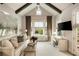 Cozy living area features a vaulted ceiling, wood beams, plenty of natural light and comfortable seating at 1129 Cordia Nw Ave, Atlanta, GA 30318