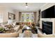 Bright living room features a corner sofa, fireplace with TV, and large windows at 1129 Cordia Nw Ave, Atlanta, GA 30318