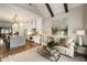 Open-concept living room and kitchen with wood floors, beamed ceiling, and access to outdoor deck at 1129 Cordia Nw Ave, Atlanta, GA 30318