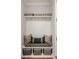 Charming mudroom features a built-in bench with storage baskets, hooks, and decorative pillows at 1129 Cordia Nw Ave, Atlanta, GA 30318