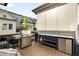 Outdoor kitchen and grilling area on a deck with stainless grill and mini fridge at 1129 Cordia Nw Ave, Atlanta, GA 30318