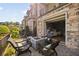 An outdoor stone patio with a concrete fire pit, black metal railings, and sliding door to bedroom at 1129 Cordia Nw Ave, Atlanta, GA 30318