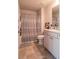 Clean bathroom with a shower and bathtub combination, along with a white vanity and storage cabinet at 1809 Park Land Ln, Snellville, GA 30078