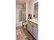 Clean bathroom with a shower and bathtub combination, along with a white vanity and storage cabinet at 1809 Park Land Ln, Snellville, GA 30078