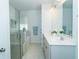 Bright bathroom with a glass shower, soaking tub, and double vanity with white countertops and modern fixtures at 1809 Park Land Ln, Snellville, GA 30078