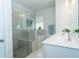 Bright bathroom with a glass shower, soaking tub, and double vanity with white countertops at 1809 Park Land Ln, Snellville, GA 30078