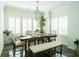 Bright dining room features a wooden table with seating for six, with natural light and modern chandelier at 1809 Park Land Ln, Snellville, GA 30078