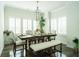 Bright dining room features a wooden table with seating for six, with natural light and modern chandelier at 1809 Park Land Ln, Snellville, GA 30078