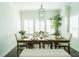 Inviting dining room featuring a wood table with seating for six, complemented by natural light from shuttered windows at 1809 Park Land Ln, Snellville, GA 30078