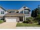 Charming two-story home with stone accents, neutral siding, and a well-maintained lawn, complemented by a two-car garage at 1809 Park Land Ln, Snellville, GA 30078
