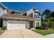 Charming two-story home with stone accents, neutral siding, and a well-maintained lawn, complemented by a two-car garage at 1809 Park Land Ln, Snellville, GA 30078