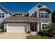 Charming two-story home with stone accents, neutral siding, and a well-maintained lawn, complemented by a two-car garage at 1809 Park Land Ln, Snellville, GA 30078
