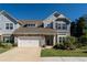 Charming two-story home with stone accents, neutral siding, and a well-maintained lawn, complemented by a two-car garage at 1809 Park Land Ln, Snellville, GA 30078