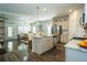 Open-concept kitchen flowing into the living area, featuring a large island, stainless steel appliances, and hardwood floors at 1809 Park Land Ln, Snellville, GA 30078