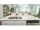 Open-concept kitchen island featuring a granite countertop, stainless steel appliances, and views to the living room at 1809 Park Land Ln, Snellville, GA 30078