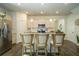 Bright kitchen featuring a center island with seating, stainless steel appliances, and stylish pendant lighting at 1809 Park Land Ln, Snellville, GA 30078