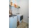Efficient laundry room with modern washer and dryer, storage shelves, and practical design at 1809 Park Land Ln, Snellville, GA 30078