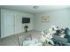 Cozy living room offers neutral carpet, soothing paint color, television, and comfortable seating at 1809 Park Land Ln, Snellville, GA 30078