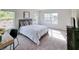 Bright main bedroom featuring a comfy bed, stylish decor, and plenty of natural light from the windows at 1809 Park Land Ln, Snellville, GA 30078