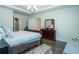 Comfortable main bedroom featuring a spacious layout, a dresser with a mirror, and hardwood floors at 1809 Park Land Ln, Snellville, GA 30078