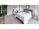 Bright main bedroom featuring a comfy bed, stylish decor, and plenty of natural light from the windows at 1809 Park Land Ln, Snellville, GA 30078