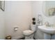 Charming powder room featuring a pedestal sink, round mirror, and decorative accents at 1809 Park Land Ln, Snellville, GA 30078