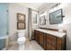 Bathroom with vanity, granite countertop, framed mirror, and elegant lighting fixtures at 3018 Bradshaw Club Dr, Woodstock, GA 30188