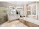 Updated bathroom featuring a glass-enclosed shower, tub, and dual sink vanity at 3018 Bradshaw Club Dr, Woodstock, GA 30188