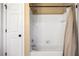 Bathroom featuring a shower-tub combo with white tile and white fixtures at 3018 Bradshaw Club Dr, Woodstock, GA 30188